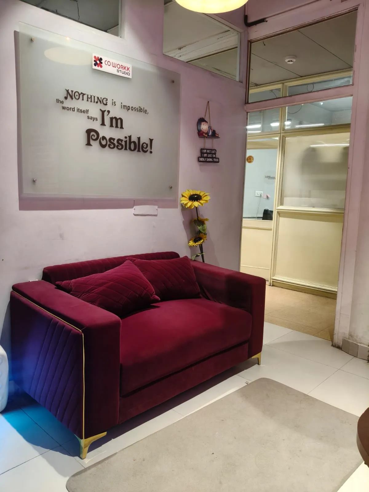 COWORKK STUDIO Lounge - Velvet sofa with I'm Possible wall quote